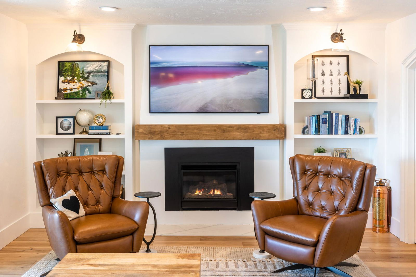 A living room with two chairs and a fireplace