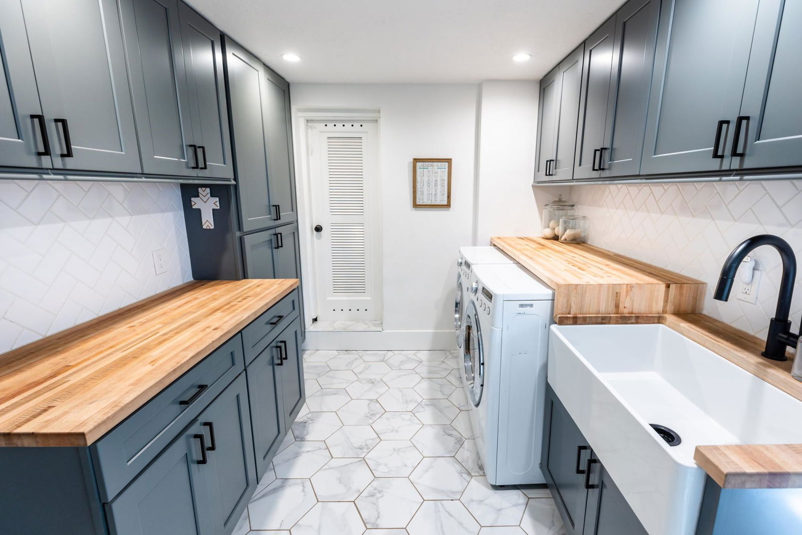 A kitchen with a washer and dryer in it