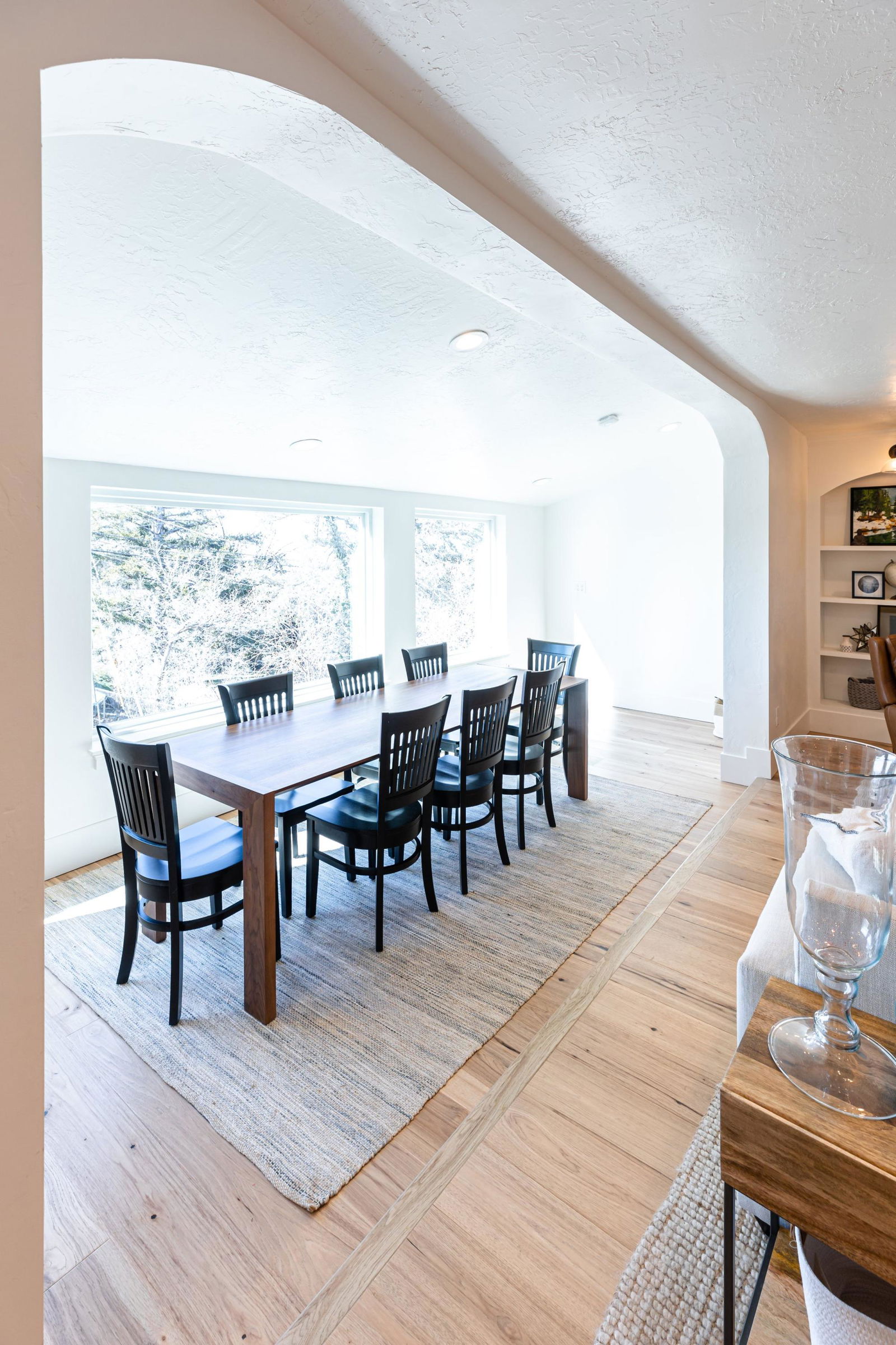 A dining room with a table and chairs