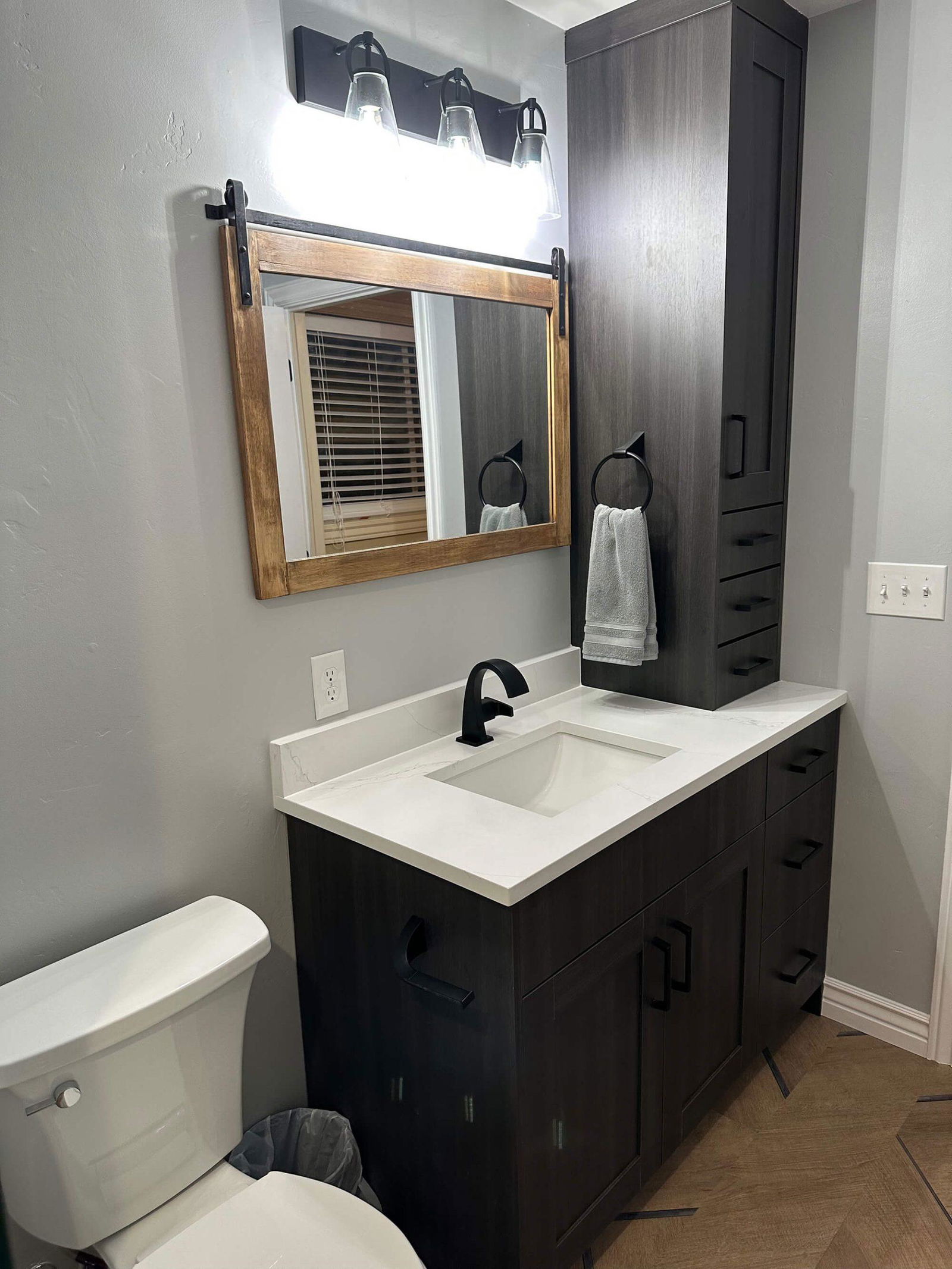 A white toilet sitting next to a bathroom sink