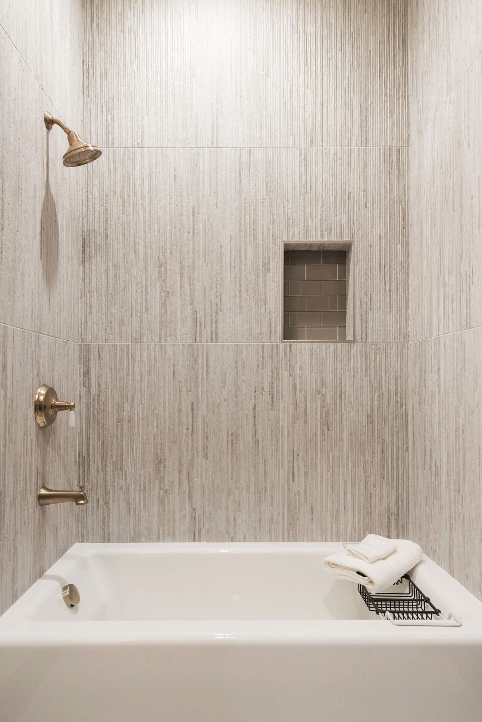 A white bath tub sitting next to a shower head