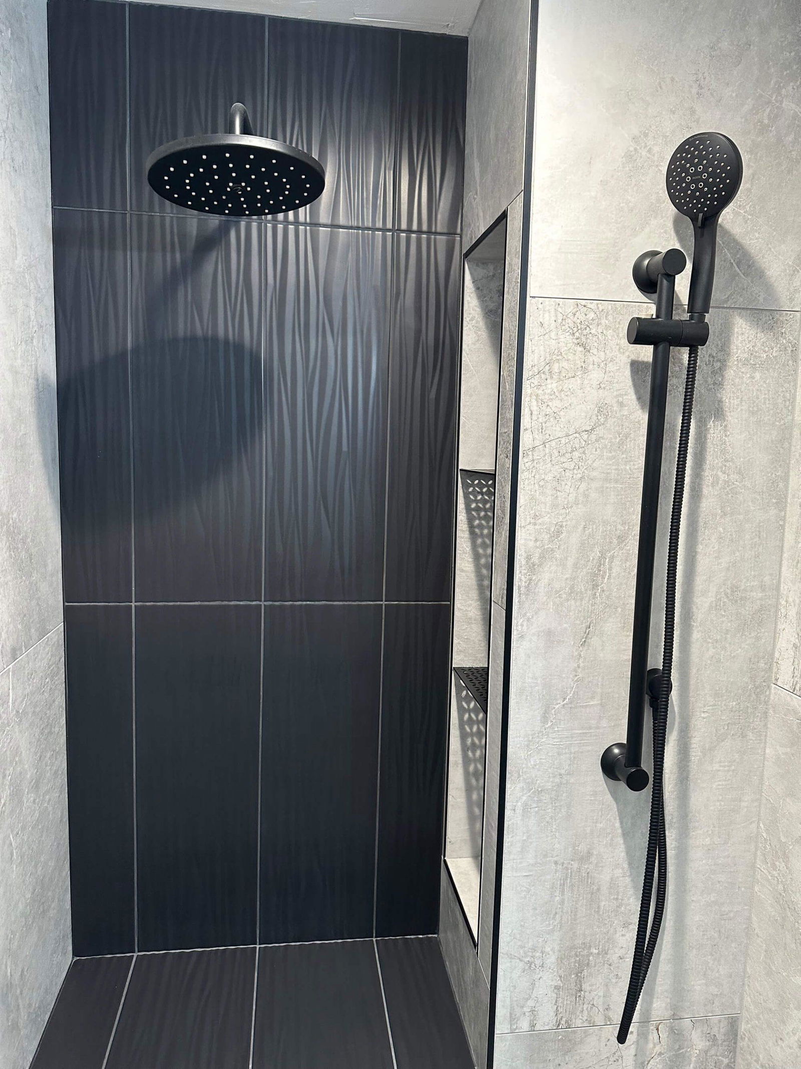 A walk in shower sitting next to a shower head