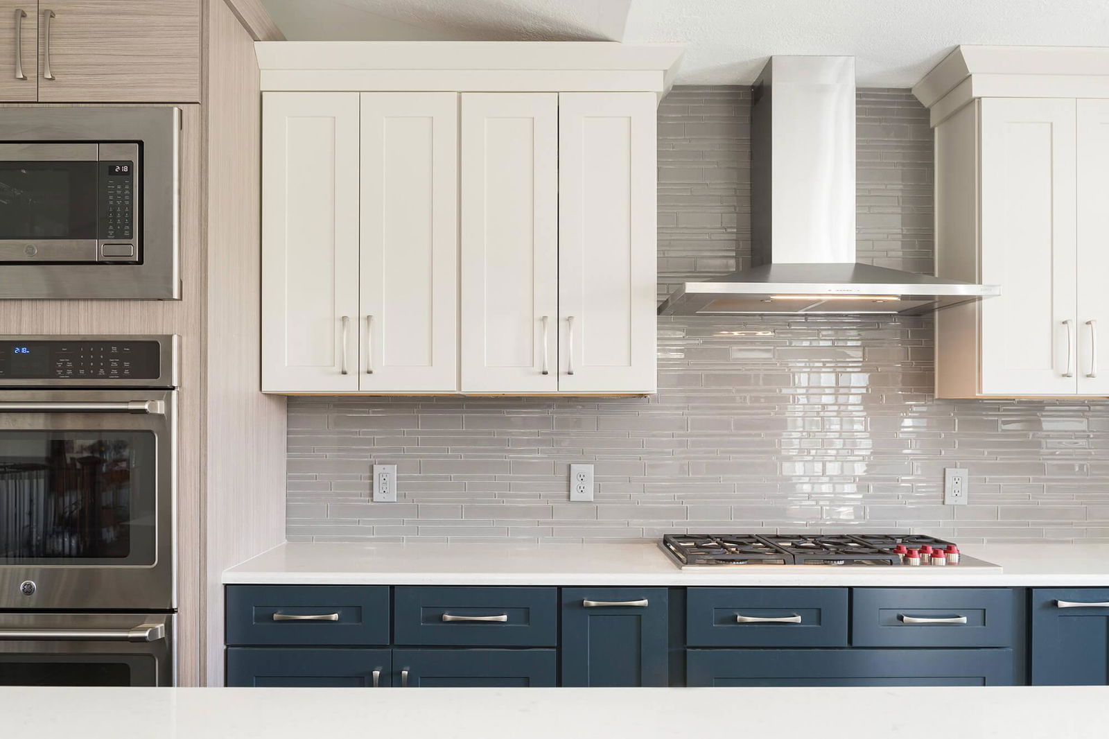 A kitchen with a stove, oven, microwave and cabinets