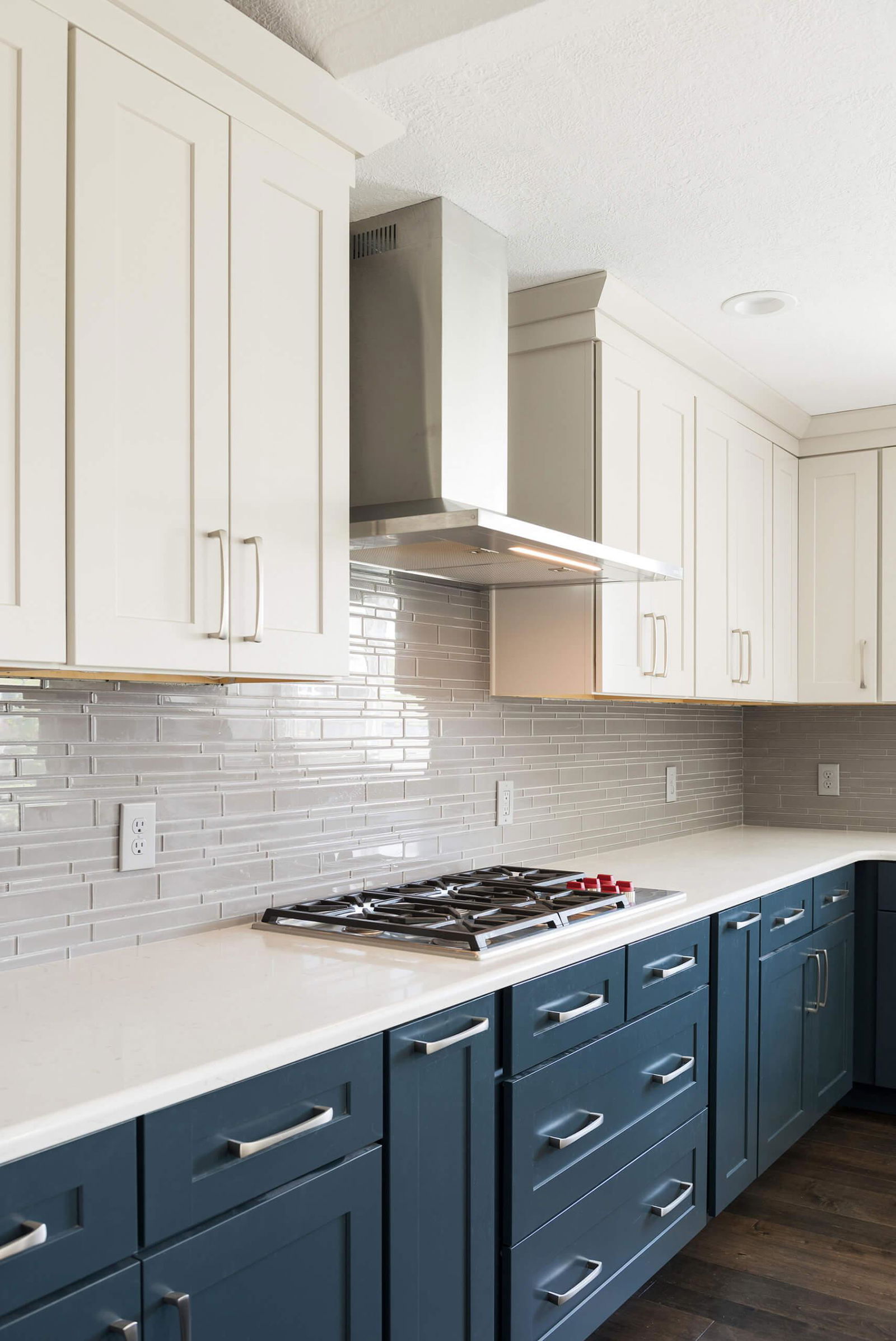 A kitchen with blue cabinets and white counter tops