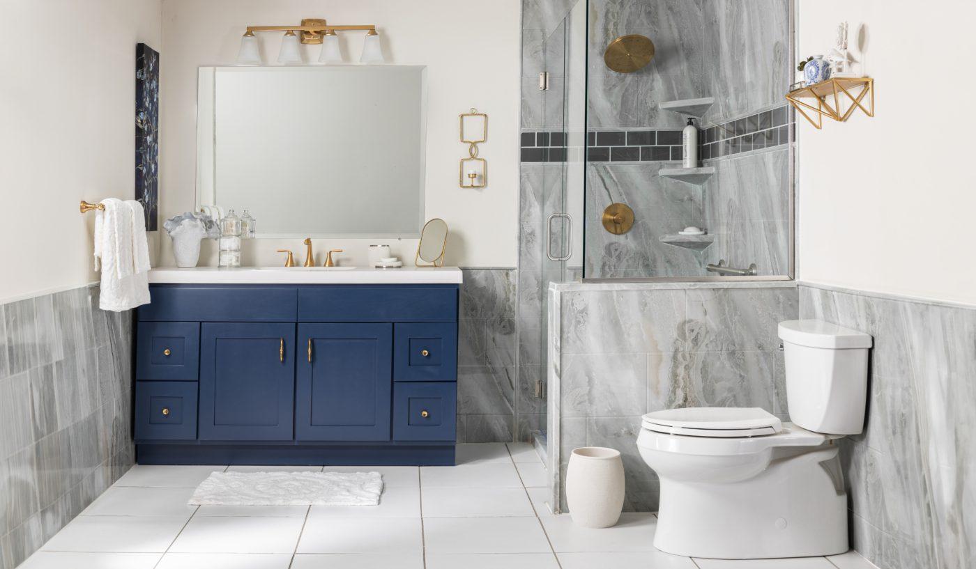 A bathroom with a blue cabinet and a white toilet