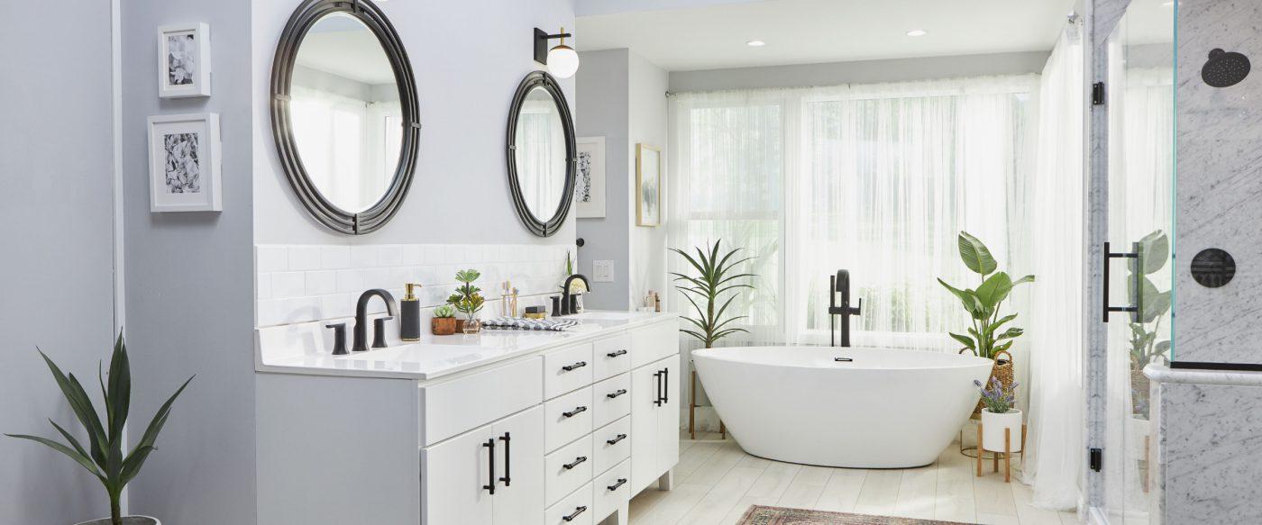 A bathroom with a tub, sink, and mirror