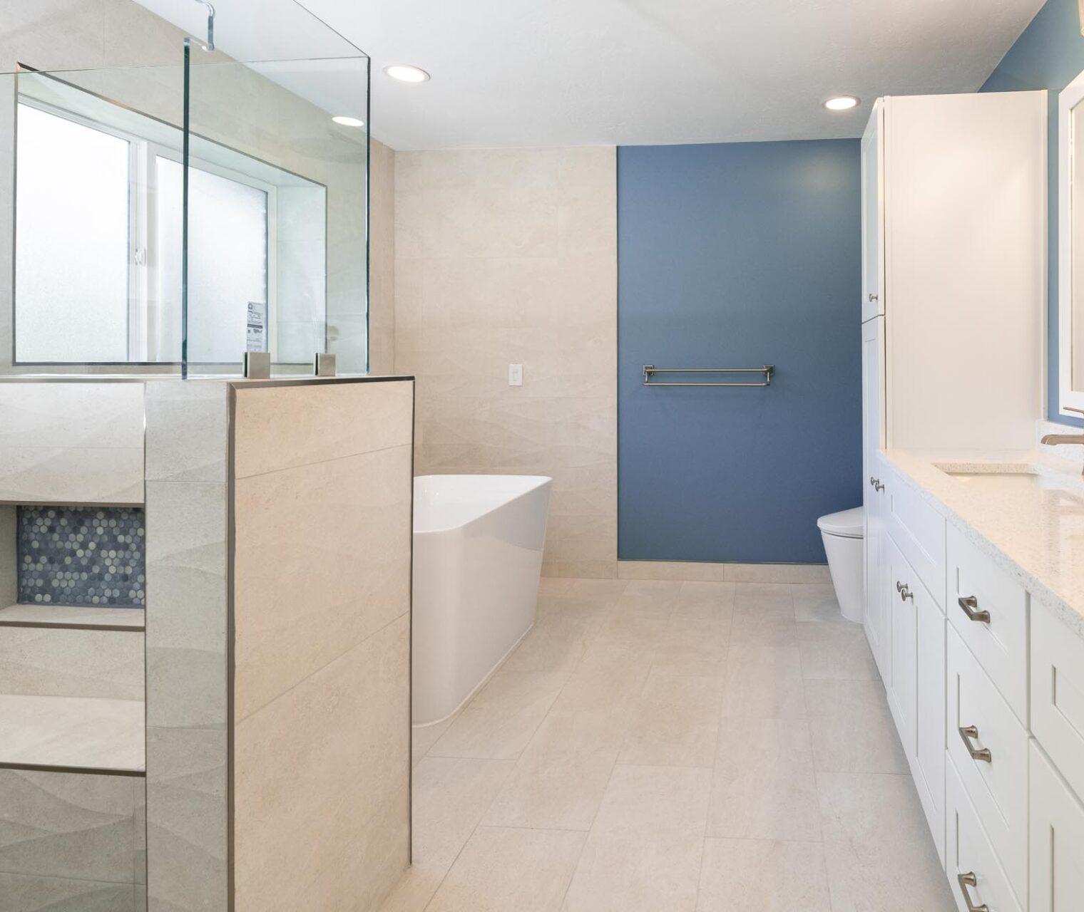 A large bathroom with a blue accent wall