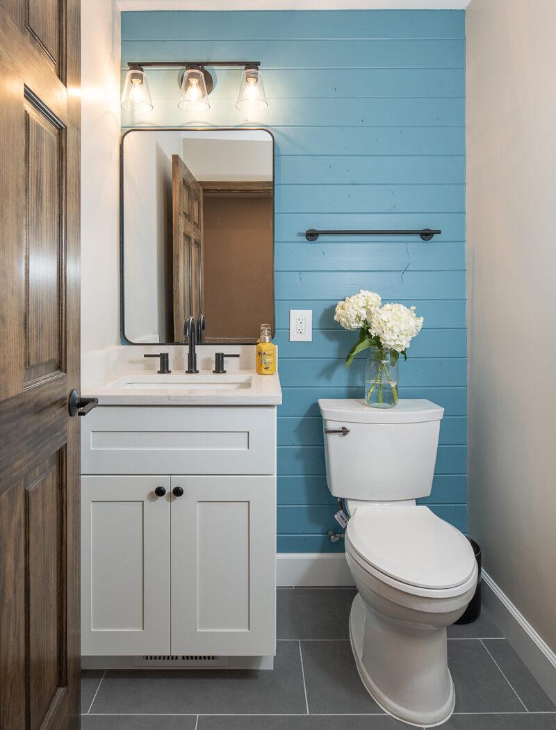 A white toilet sitting next to a bathroom sink