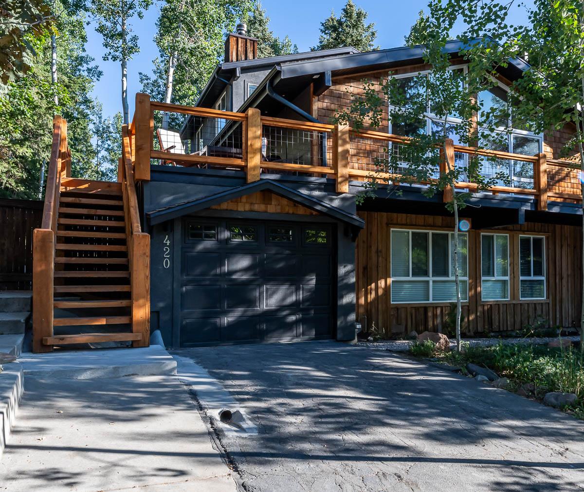 A house with a garage and stairs leading up to it