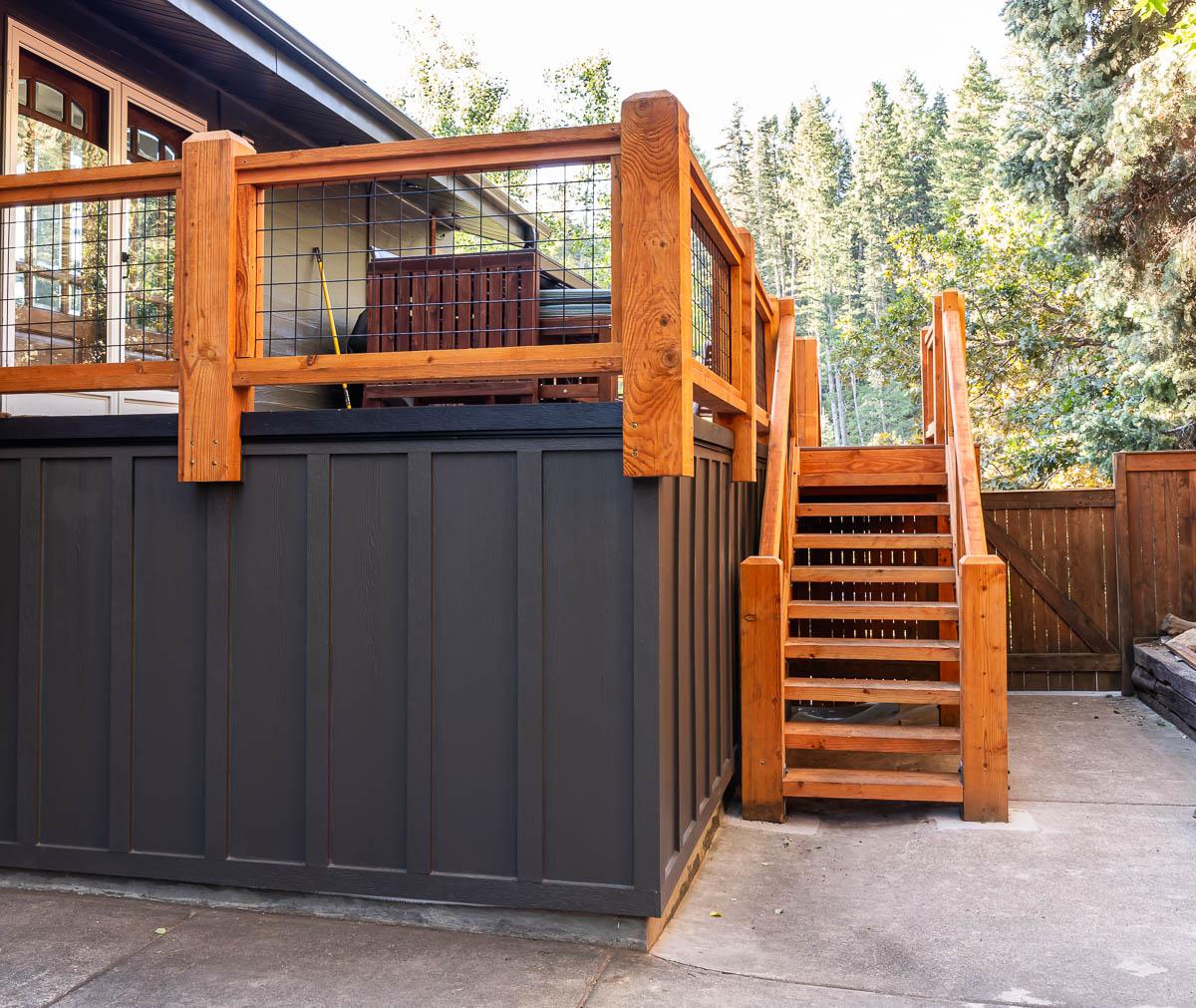 A house with a deck and stairs leading up to it