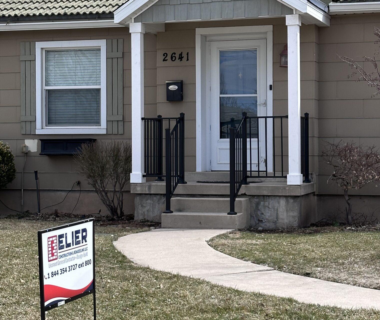 A house with a for sale sign in front of it