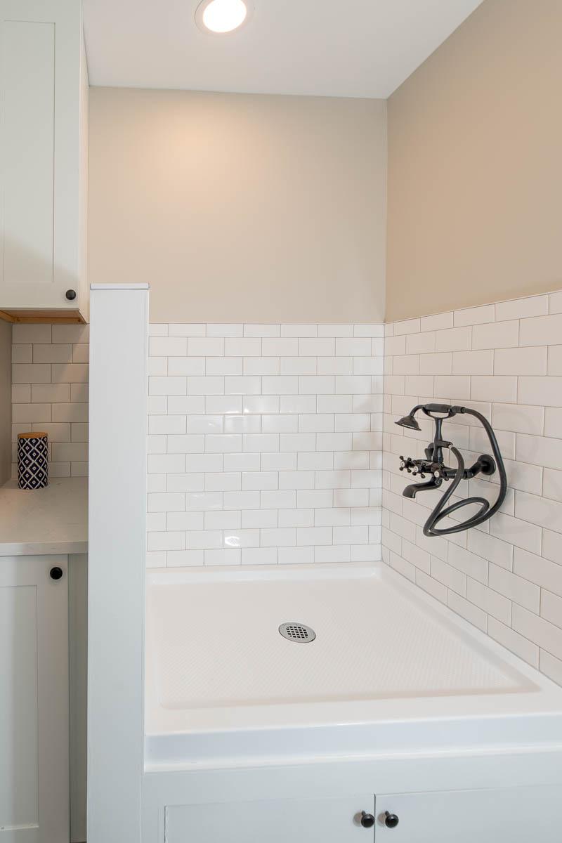 A bathroom with a shower and a sink