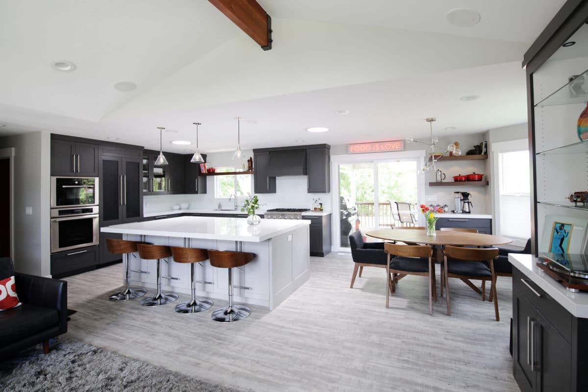 A large kitchen with a center island and bar stools