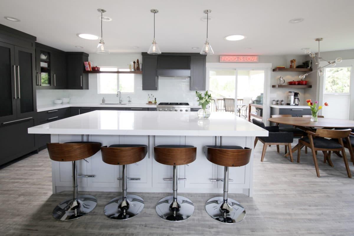 A kitchen with a center island with four stools