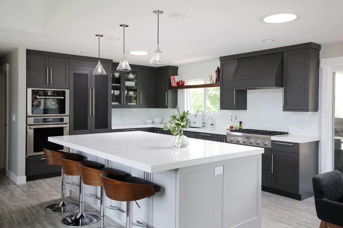 A large kitchen with a center island and bar stools