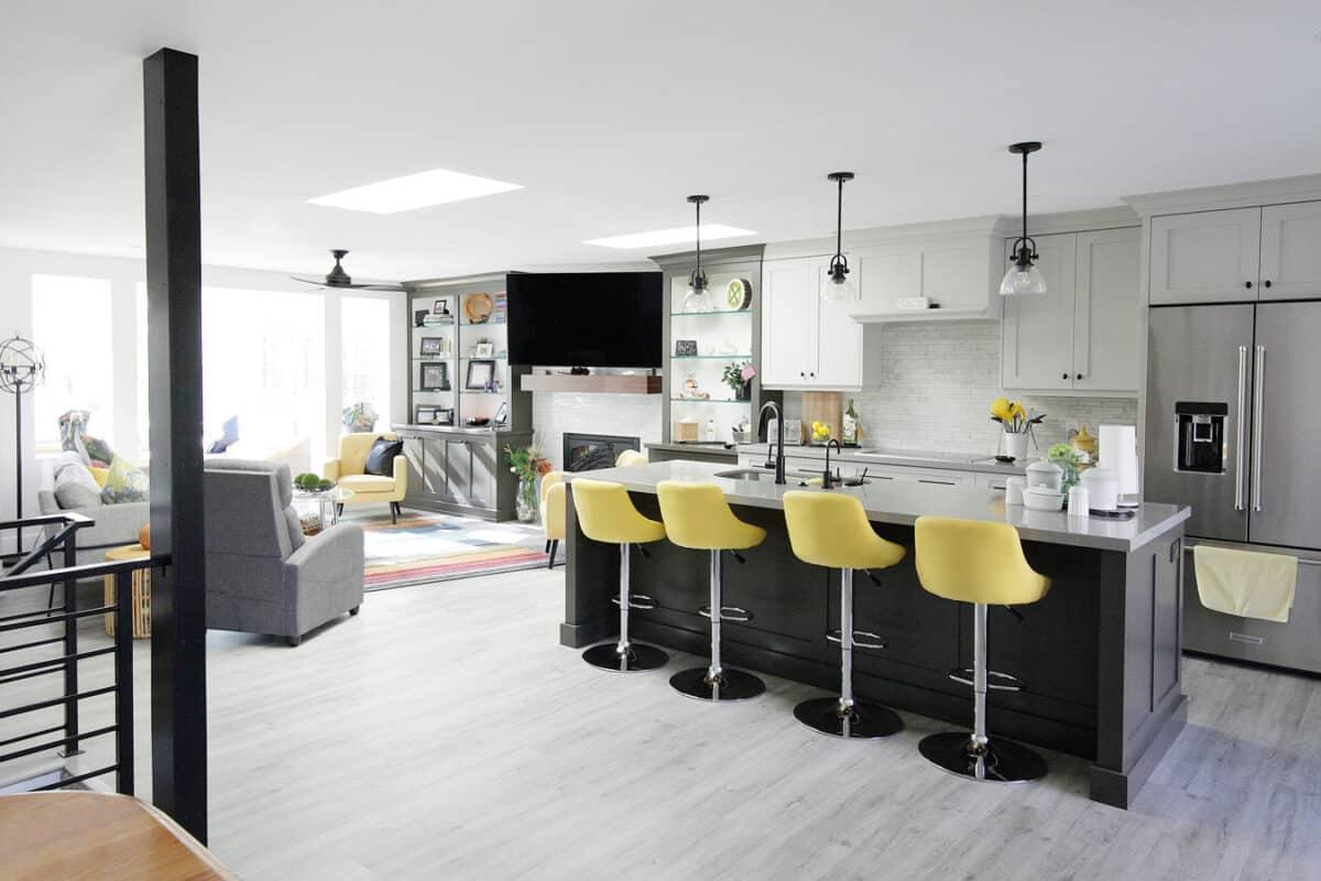 A kitchen with a center island and yellow bar stools