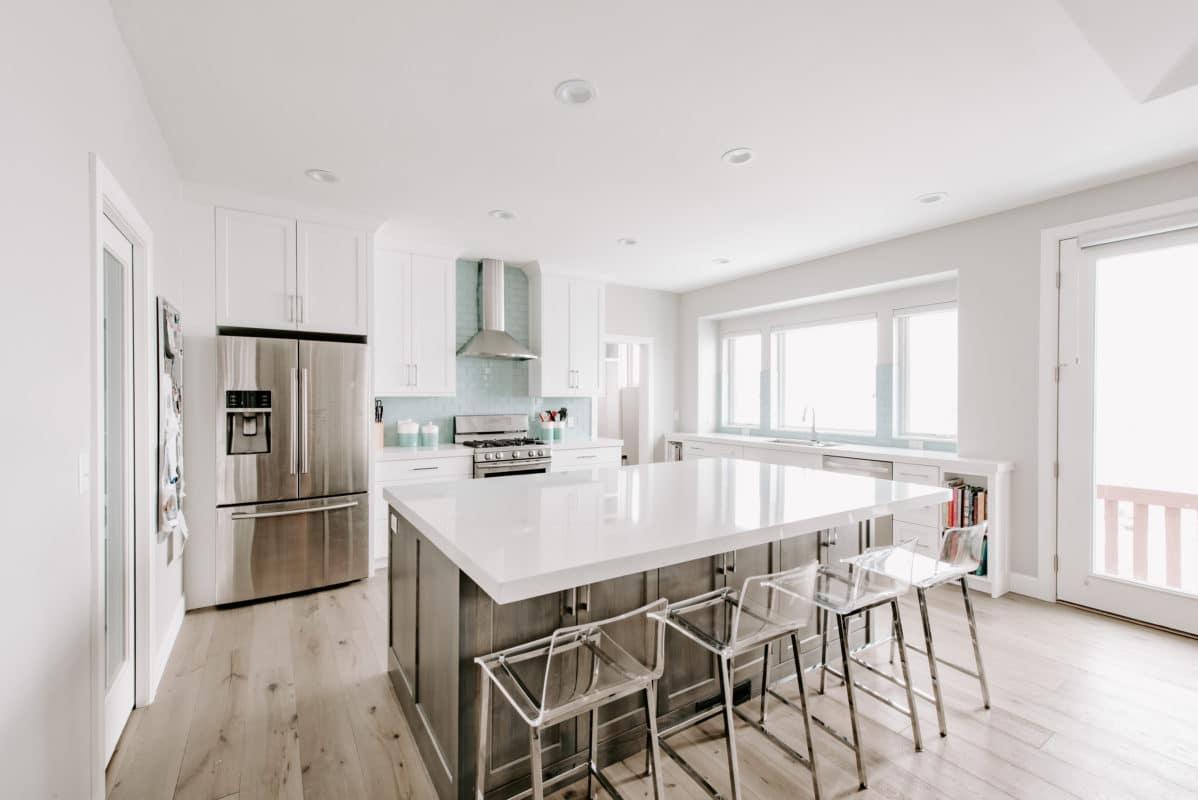 A large kitchen with a center island and stainless steel appliances