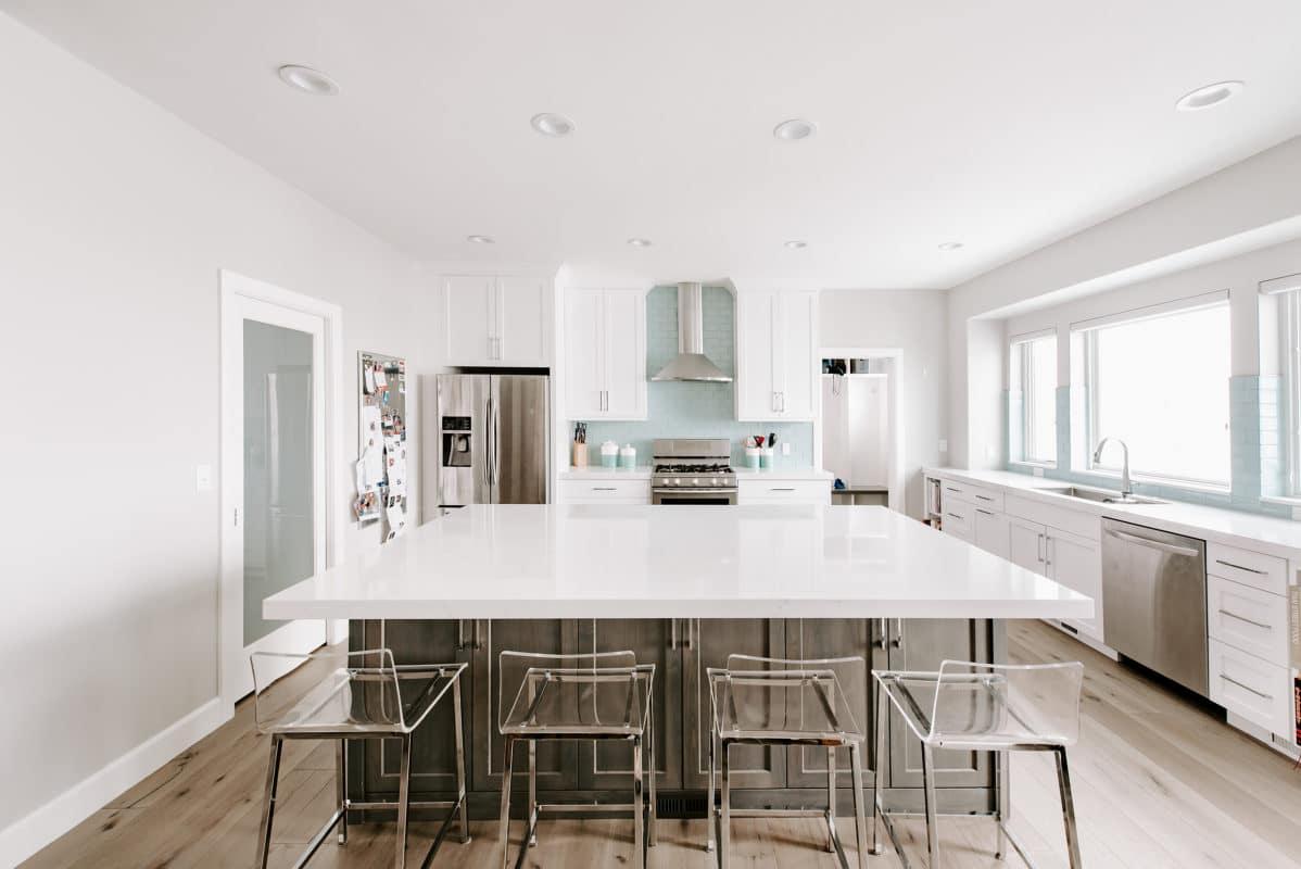 A large kitchen with a center island with chairs