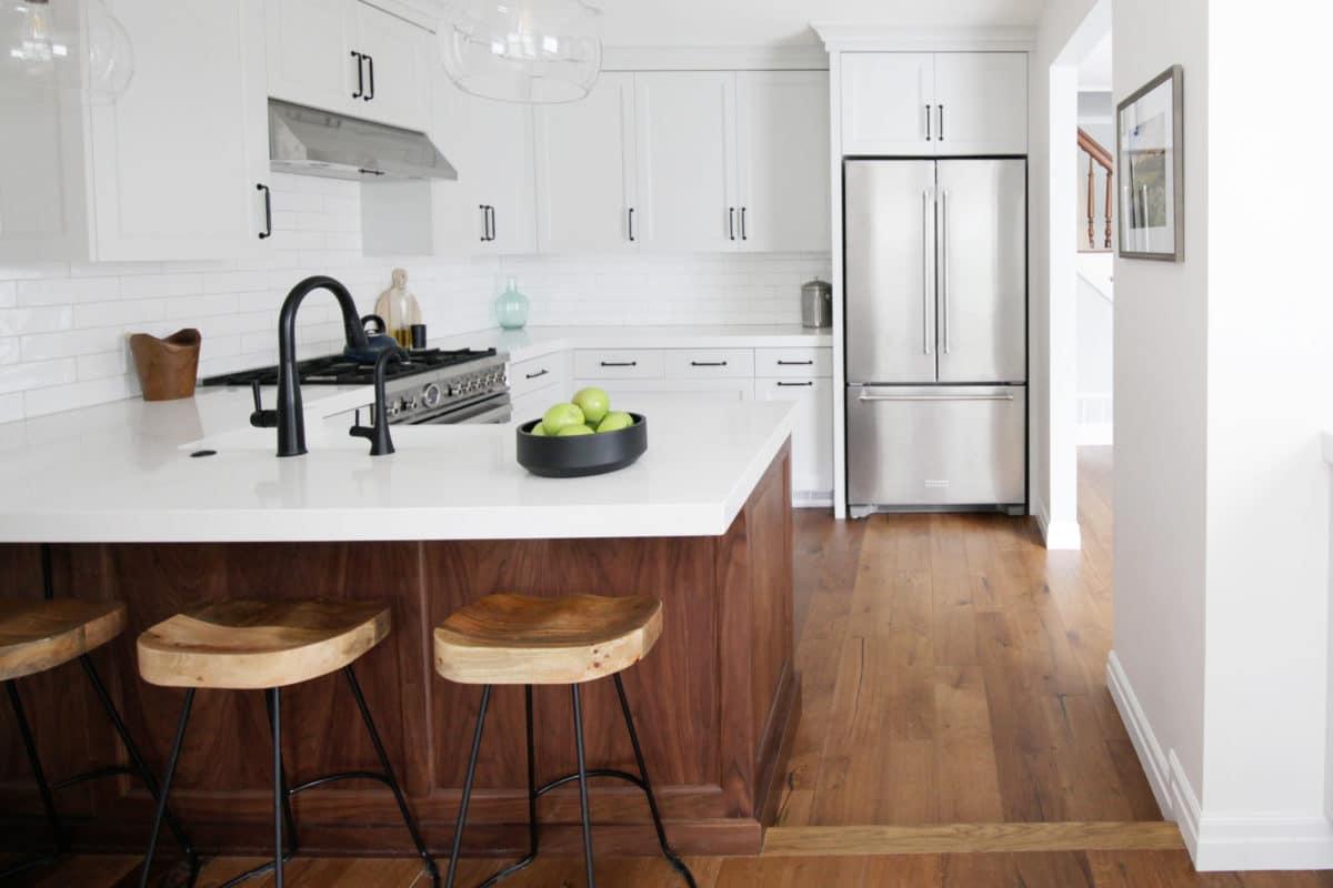 A kitchen with a center island with stools