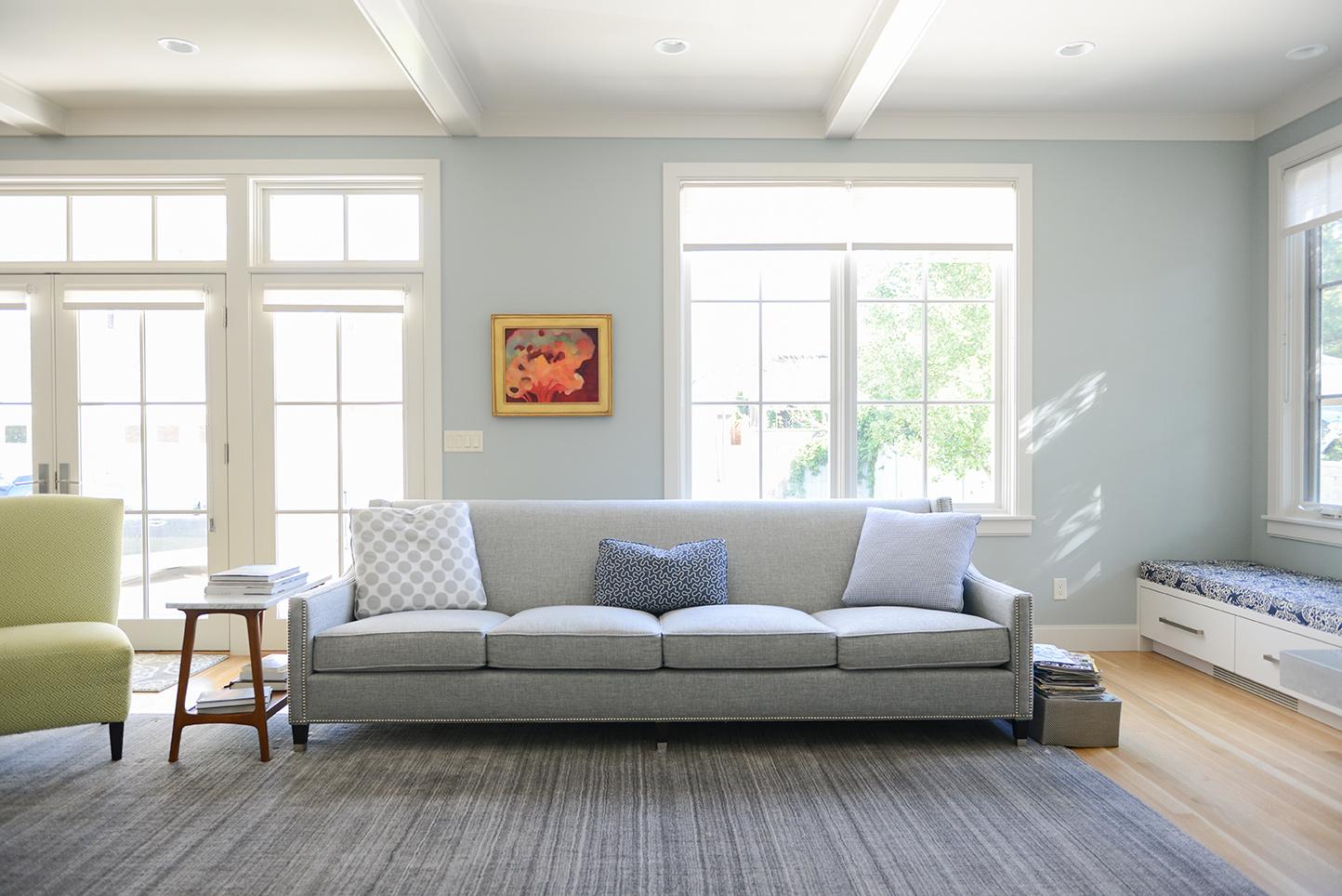 A living room filled with furniture and windows