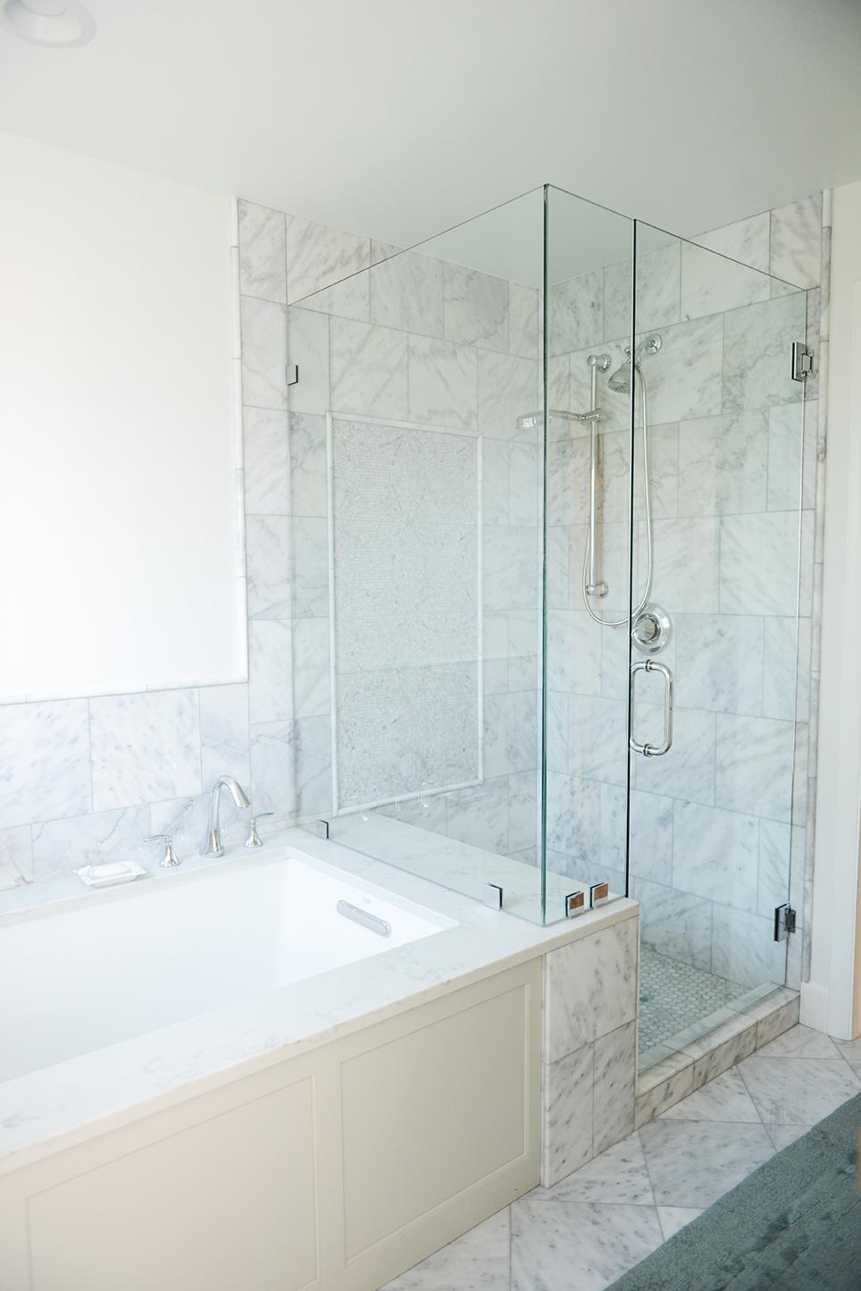 A bathroom with a tub and a walk in shower