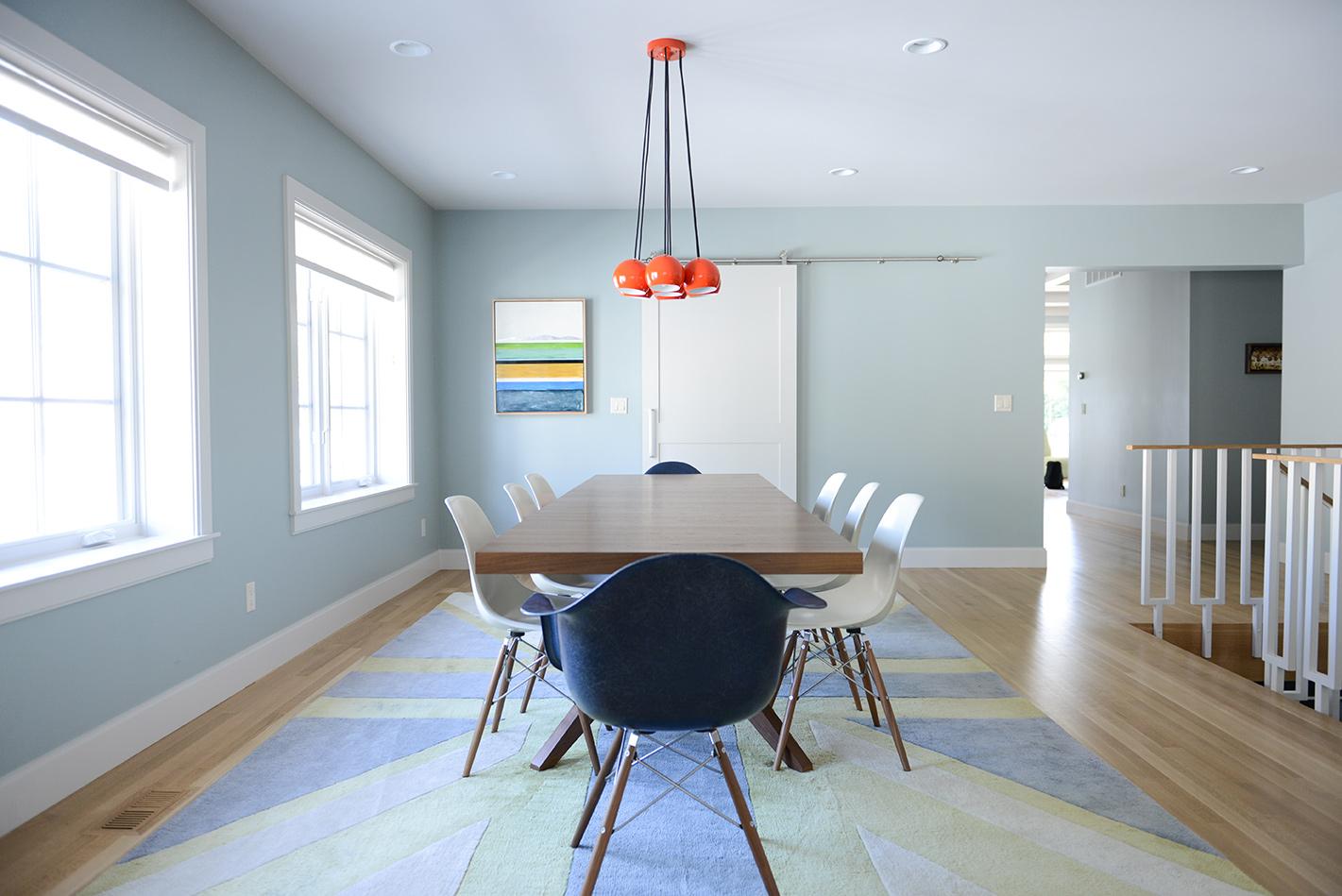 A dining room with a table and chairs