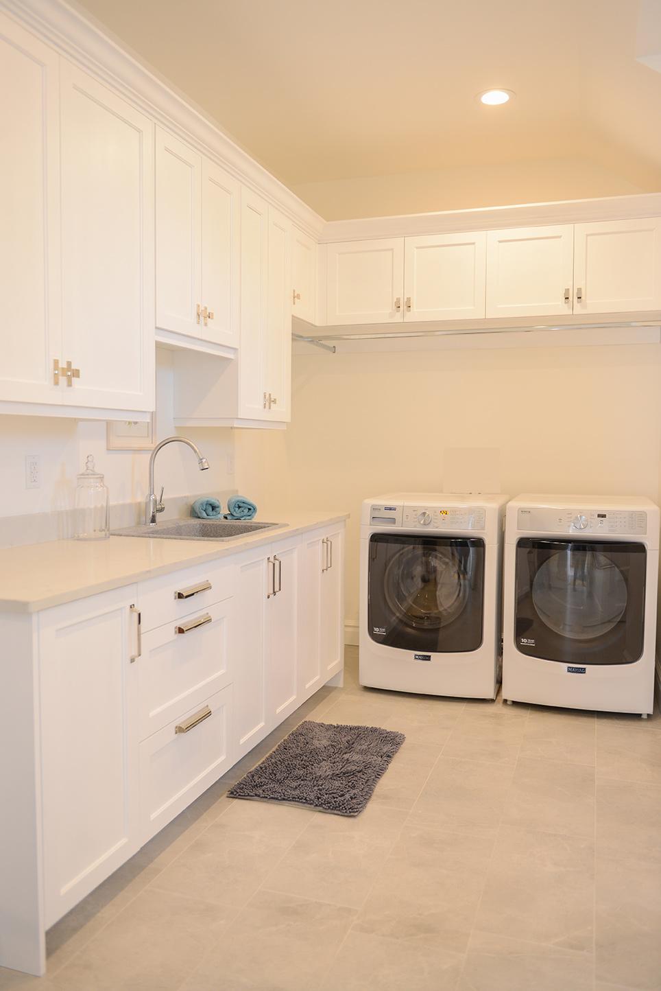 A kitchen with a washer and dryer in it