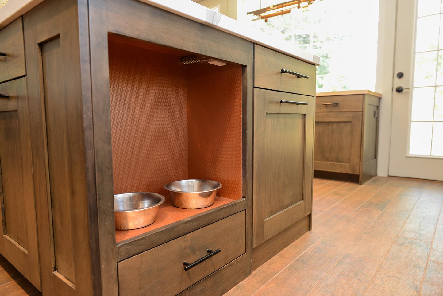 A wooden cabinet with two bowls in it