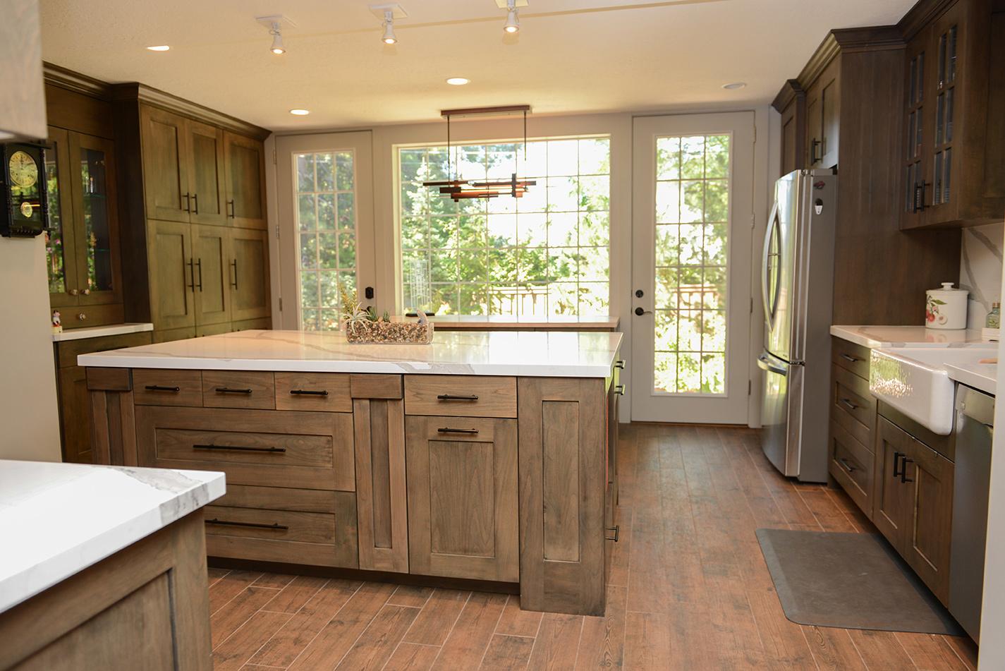 A kitchen with wooden cabinets and white counter tops