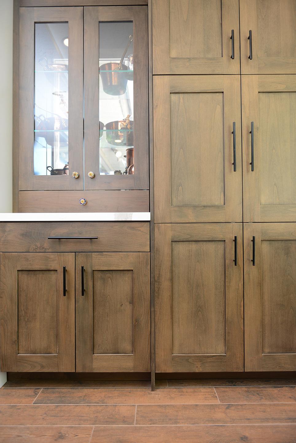 A kitchen with wooden cabinets and a white counter top