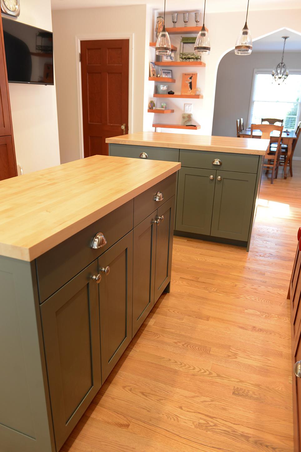 A kitchen with a center island and wooden floors