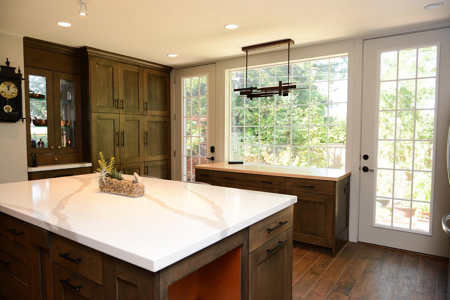 A kitchen with a center island and a clock on the wall