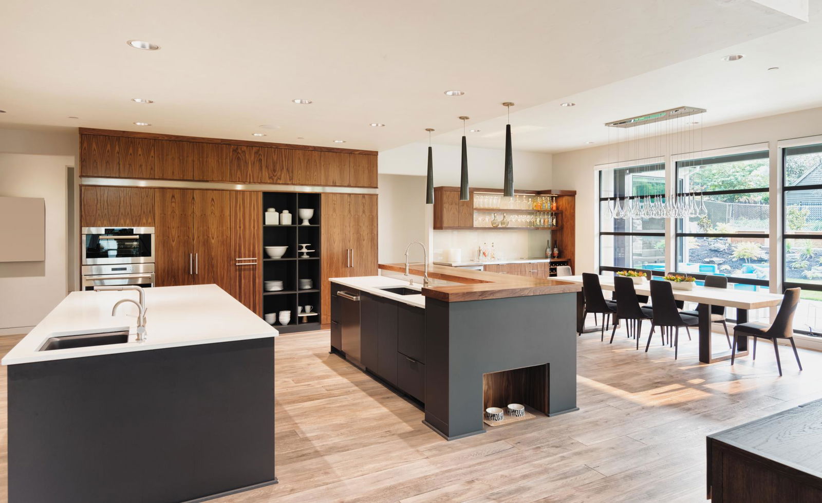 A kitchen with a center island next to a dining room table