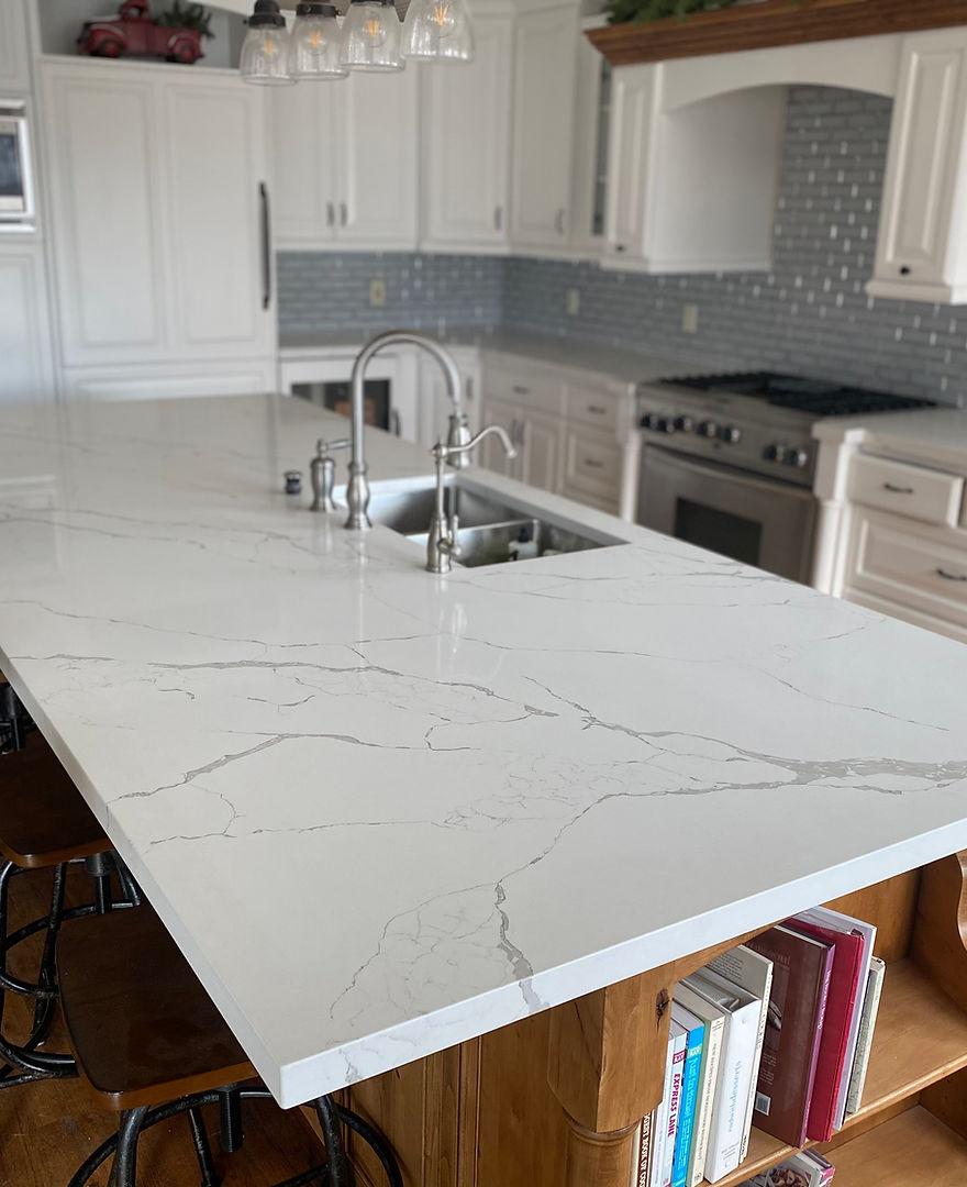 A kitchen island with a marble counter top