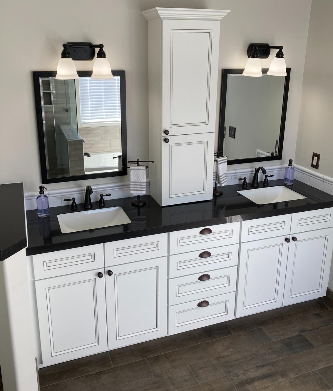 A bathroom with two sinks and two mirrors