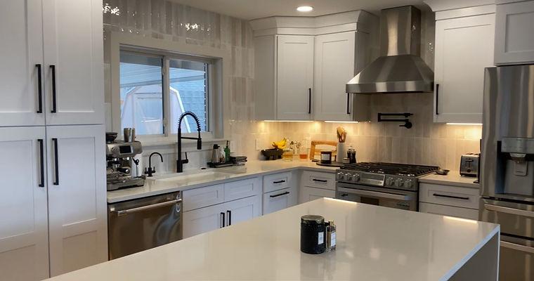 A kitchen with stainless steel appliances and white cabinets