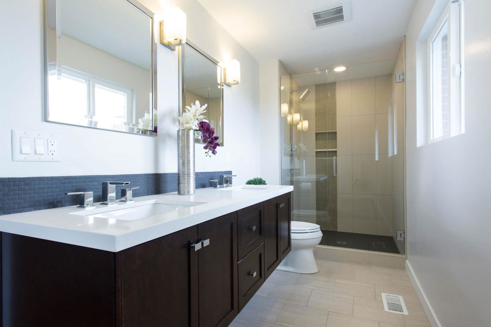 A bathroom with a toilet, sink, and shower