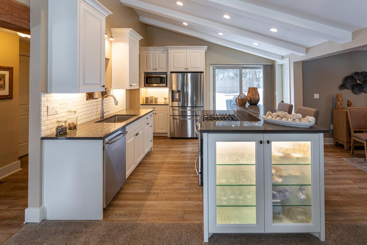 A kitchen with a center island and a refrigerator