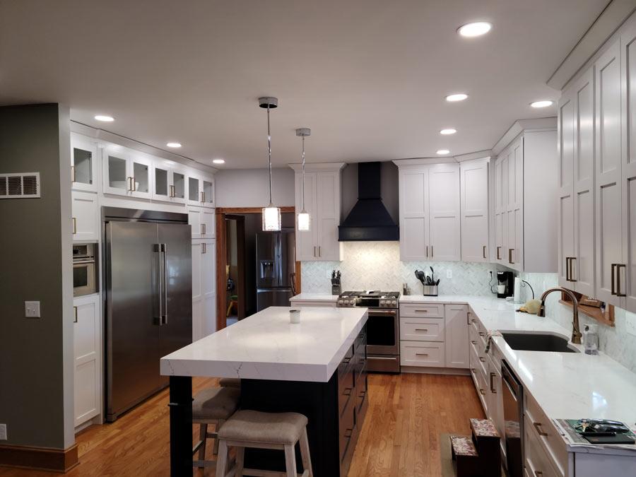 A large kitchen with a center island and white cabinets