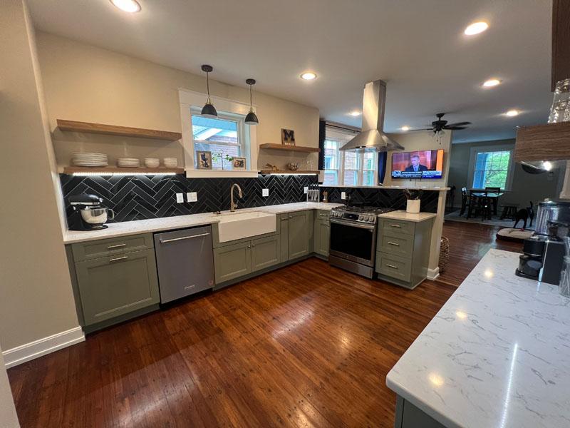 A kitchen with a stove, sink, dishwasher, and refrigerator