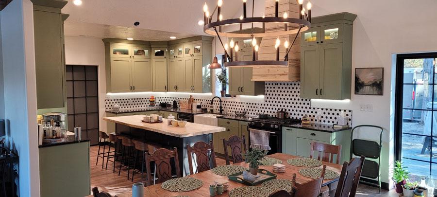 A kitchen with a table and chairs and a chandelier