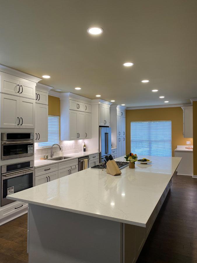 A large kitchen with a center island in the middle of the room