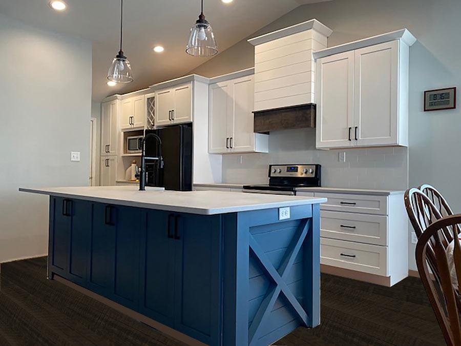 A kitchen with white cabinets and a blue island