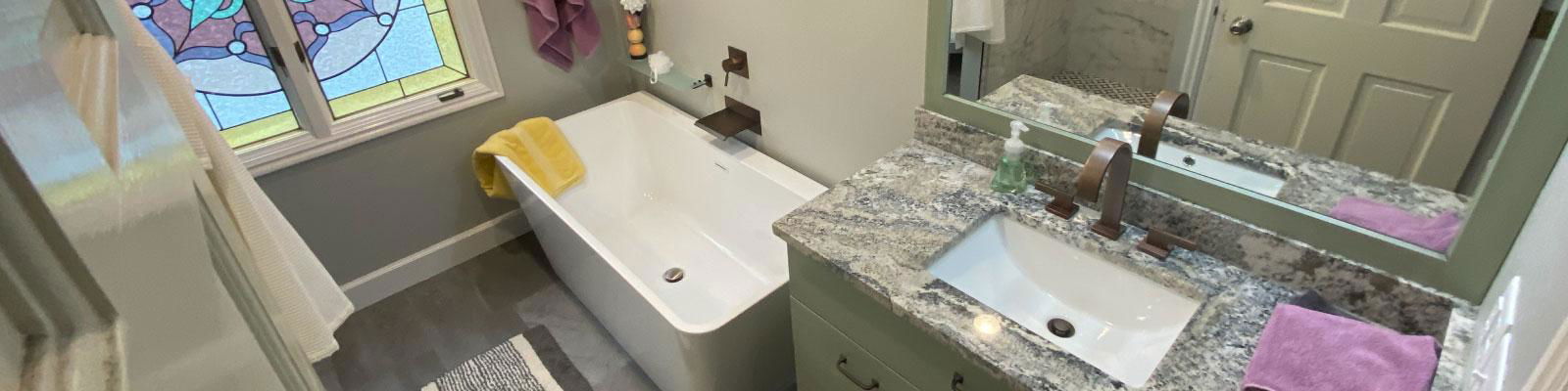 A bathroom with a sink and a stained glass window