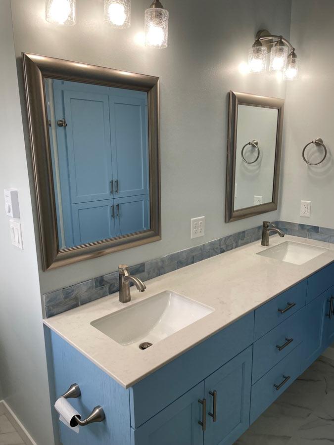 A bathroom with two sinks and two mirrors