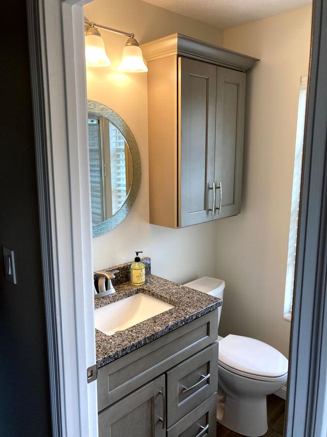 A white toilet sitting next to a bathroom sink