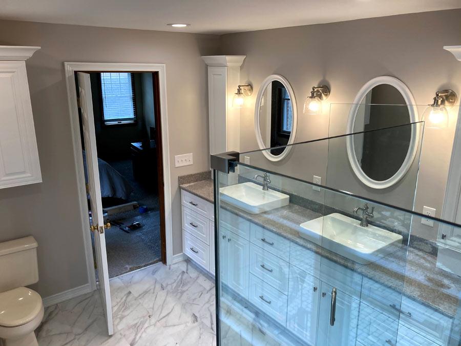 A bathroom with double sinks and a large mirror