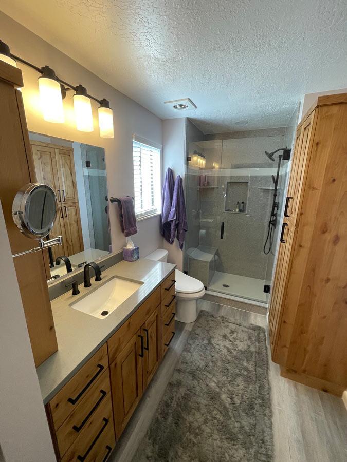 A bathroom with a sink, toilet, and shower