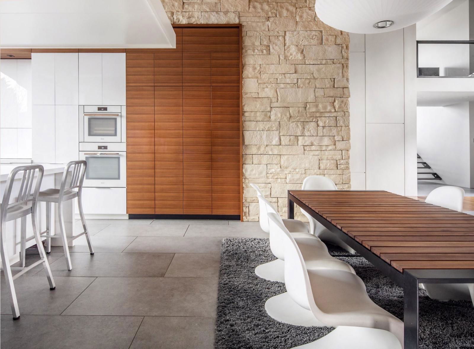 A kitchen with a table, chairs and a stove