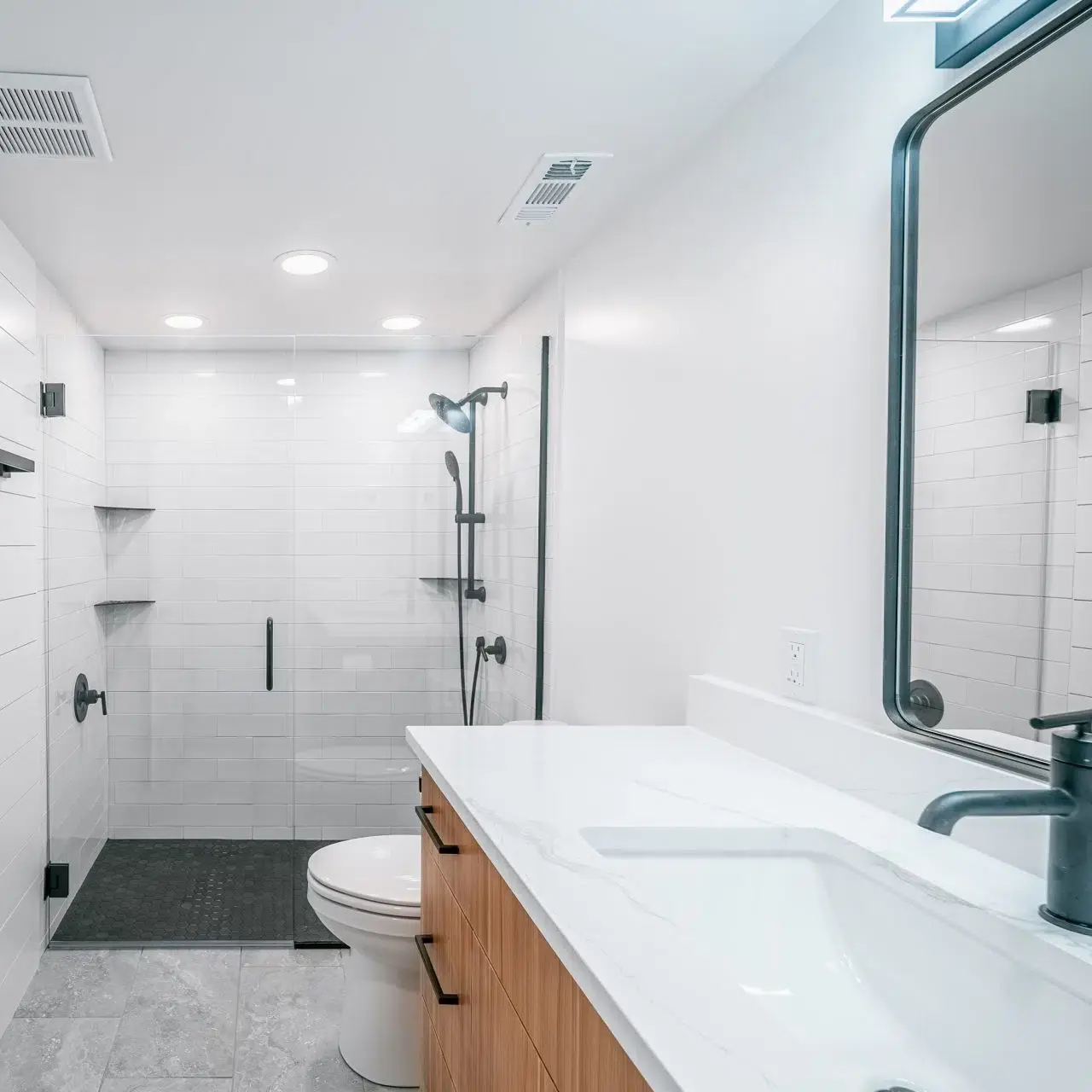 A bathroom with a sink, toilet, and shower